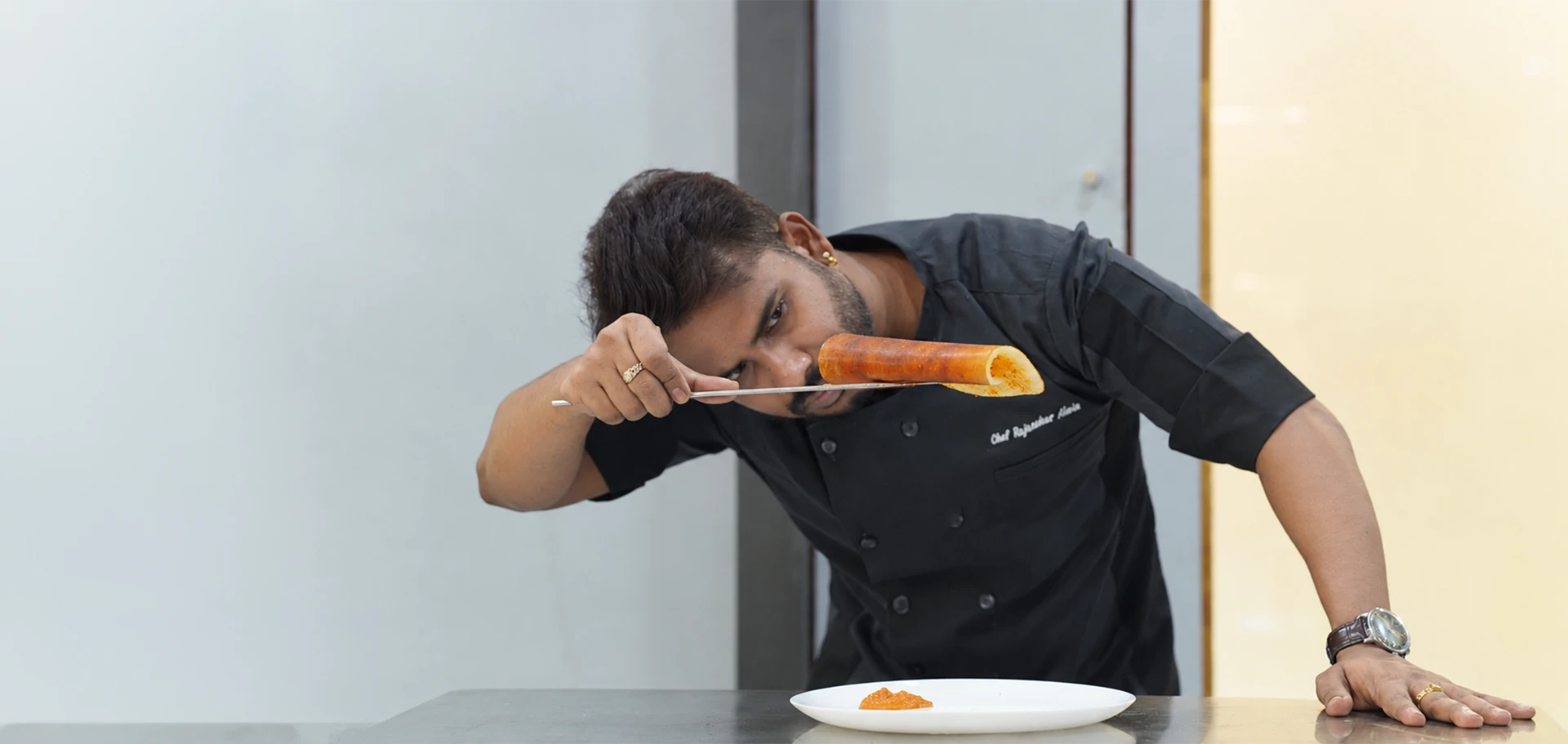 Chef Rajasekar presenting a freshly prepared dosa